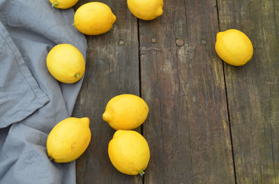 Fresh lemons on rustic wood tabletop