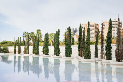 Panoramic view of swimming pool by lake against sky