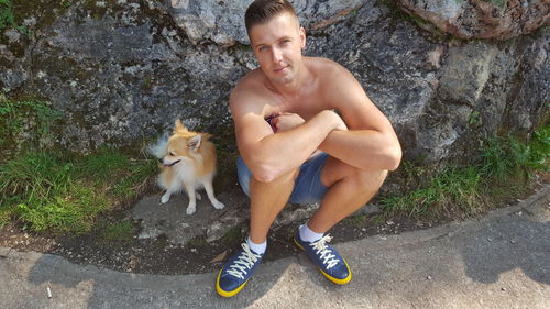 Man with dog sitting outdoors