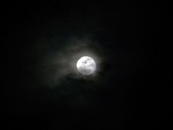 Low angle view of moon against dark sky