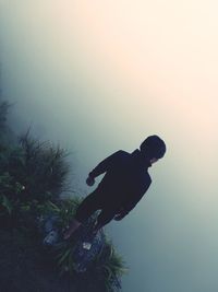 Low angle view of man against clear sky