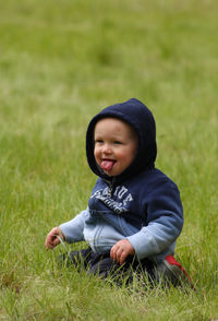 Portrait of girl relaxing on grassy field