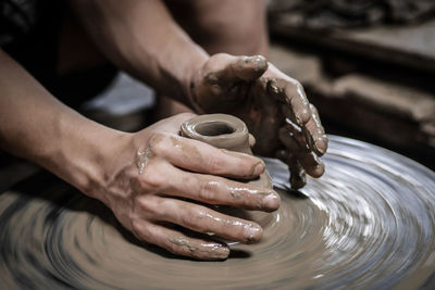 Midsection of person working in mud