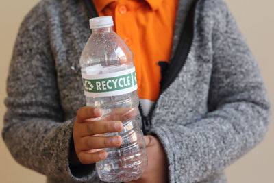 Close-up of woman holding jar with water