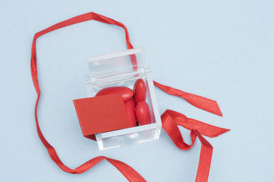 High angle view of red chili pepper on white table