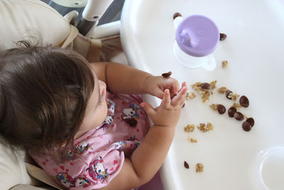 High angle view of mother playing with toy