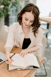 Young woman sitting on table