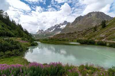 Scenic view of lake and mountains against sky