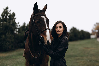 Portrait of a horse standing on field