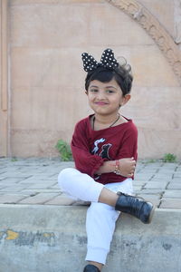 Portrait of girl sitting outdoors