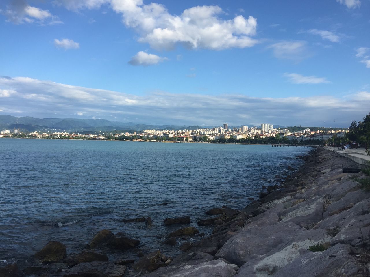 SEA BY BUILDINGS AGAINST SKY