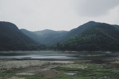 Scenic view of lake and mountains against sky