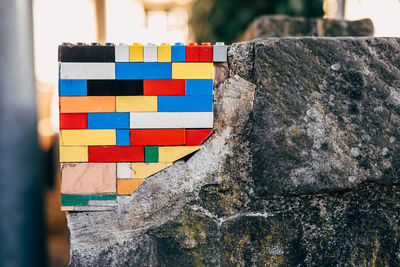 Wall on street repaired with plastic toy blocks