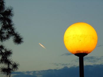 Low angle view of street light against sky at sunset