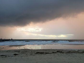 Scenic view of beach against sky during sunset