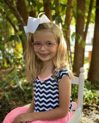 Portrait of smiling girl sitting on chair
