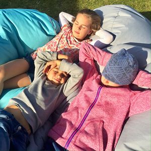 High angle view of siblings lying on bean bags