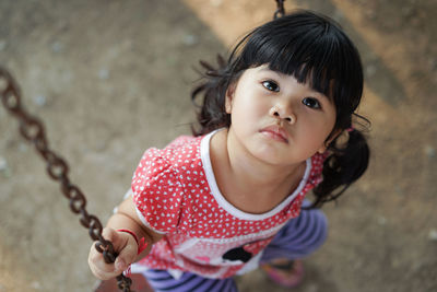 Close-up of girl on swing