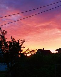 Silhouette trees against sky during sunset