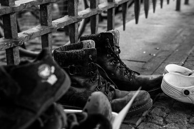 Close-up of shoes on footpath