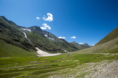 Scenic view of mountains against blue sky