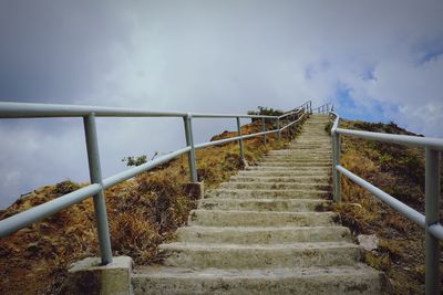 Stairs against cloudy sky