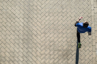 High angle view of man running on footpath