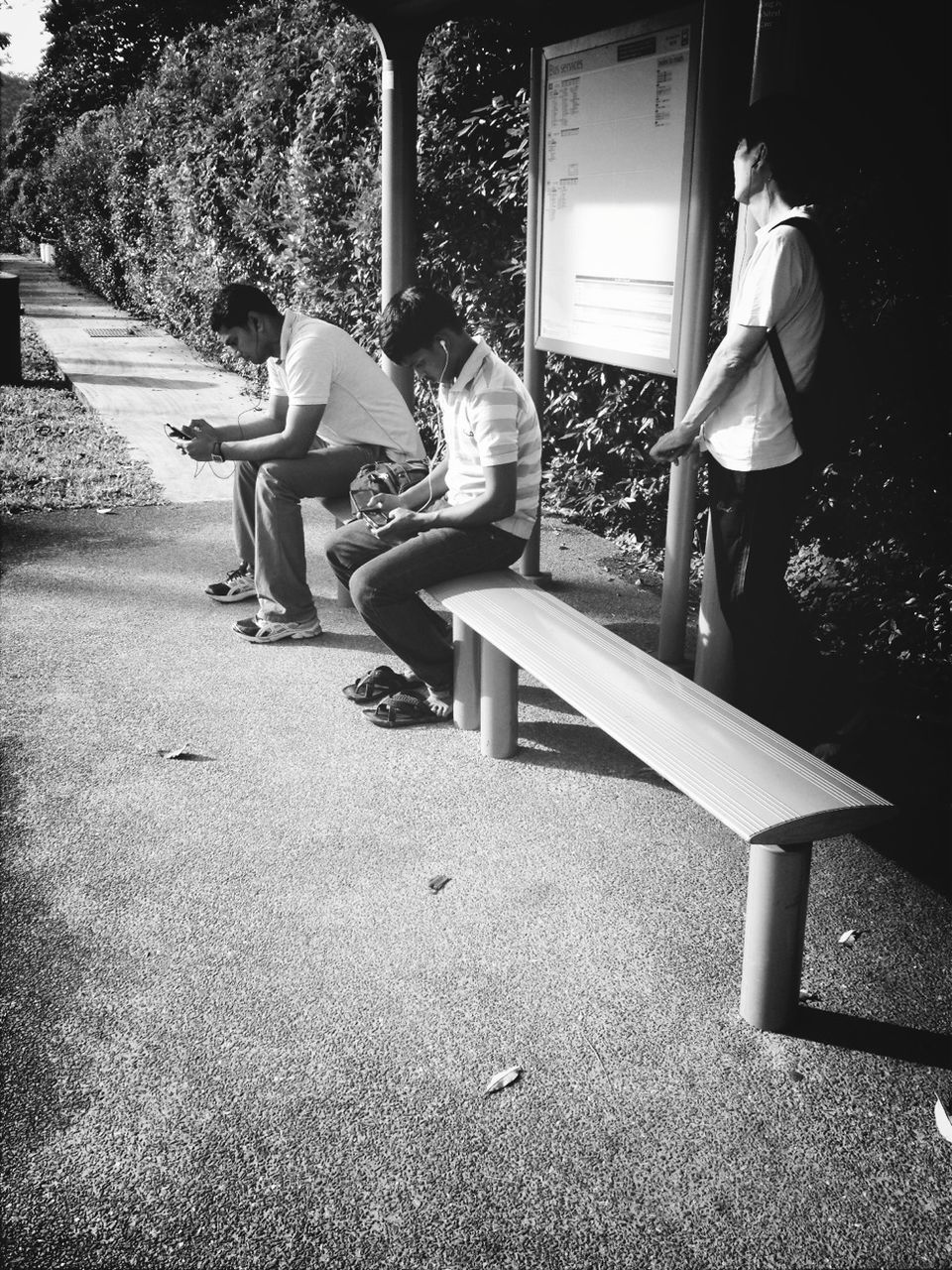 full length, leisure activity, lifestyles, chair, casual clothing, sunlight, sitting, childhood, grass, tree, person, park - man made space, relaxation, shadow, men, bench, day, rear view