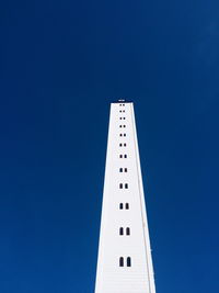 Low angle view of built structure against clear blue sky