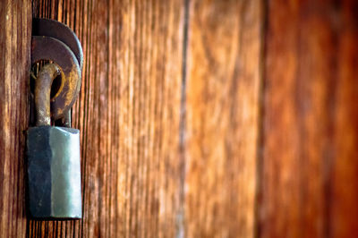 Close-up of rusty metal on table against wall