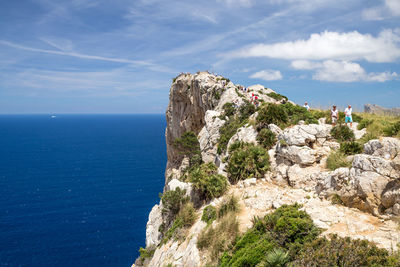 Rock formations by sea against sky