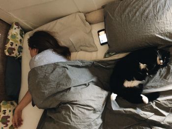 High angle view of cat sleeping on bed at home