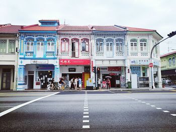 Road by building against sky