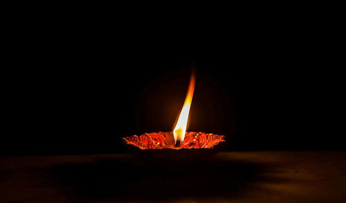 Close-up of fire burning against black background