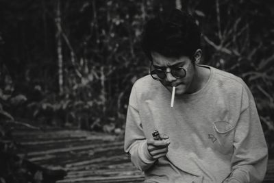 Young man smoking at the jungle