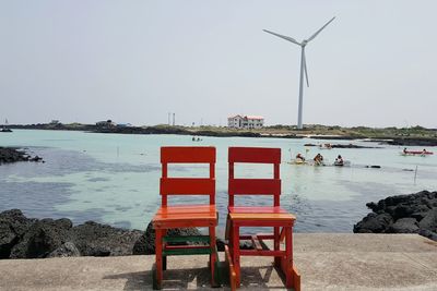 Lifeguard hut by sea against clear sky