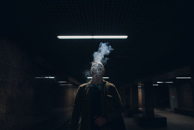 Man smoking cigarette at night