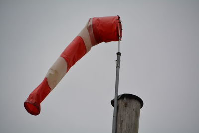 Low angle view of windsock against clear sky