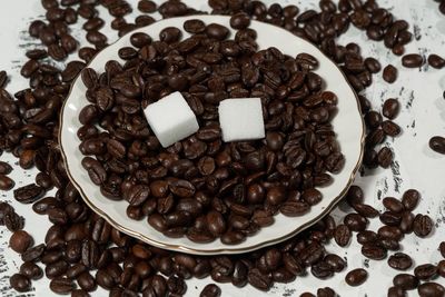 High angle view of coffee beans in glass on table