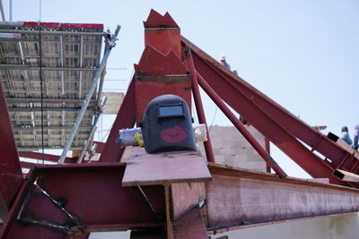 Low angle view of industry against sky