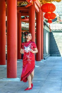 Rear view of woman standing on footpath