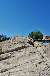 Scenic view of rocky landscape against clear blue sky