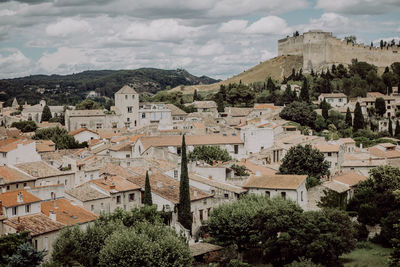 Houses in town against cloudy sky