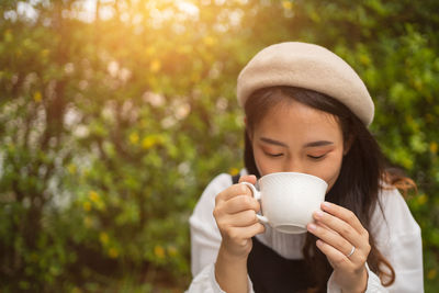 The girl in the cafe, a beautiful young woman in a cafe enjoying the taste of the drink.