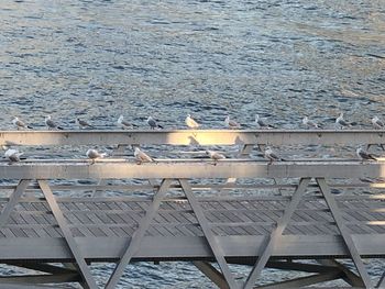 High angle view of empty chairs and table at beach