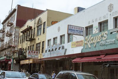 Cars on street by buildings in city