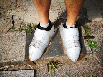 Low section of man standing on footpath