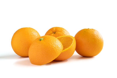 Close-up of orange fruit against white background