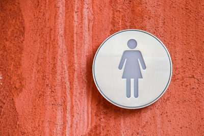 Close-up of restroom sign on wall
