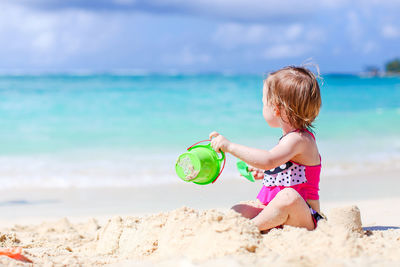 Girl playing with toy on beach